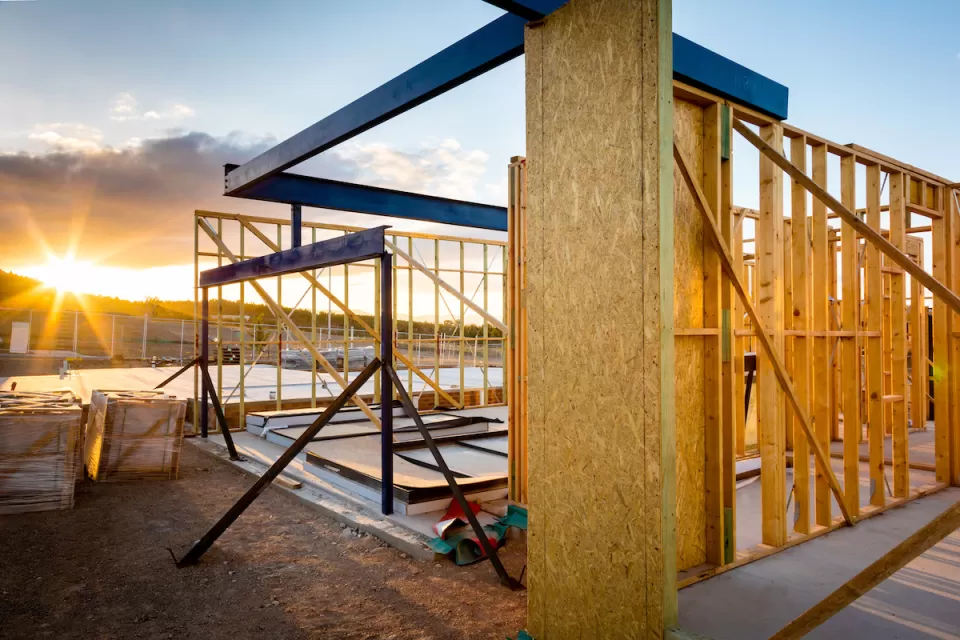 Square wood-frame home under construction.